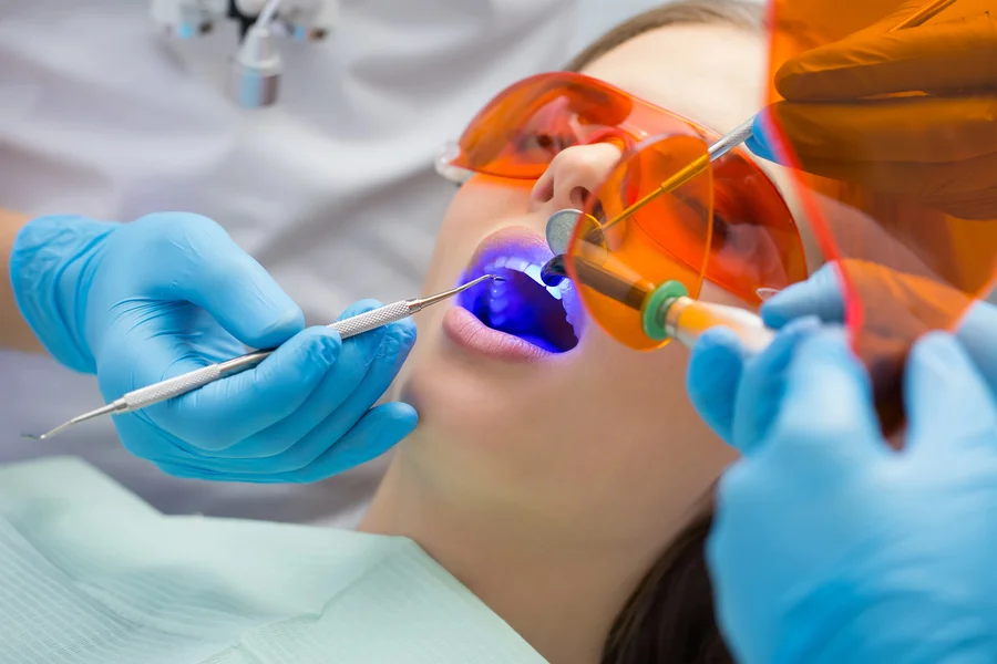 teeth whitening charlotte dentist using blue light on patient teeth